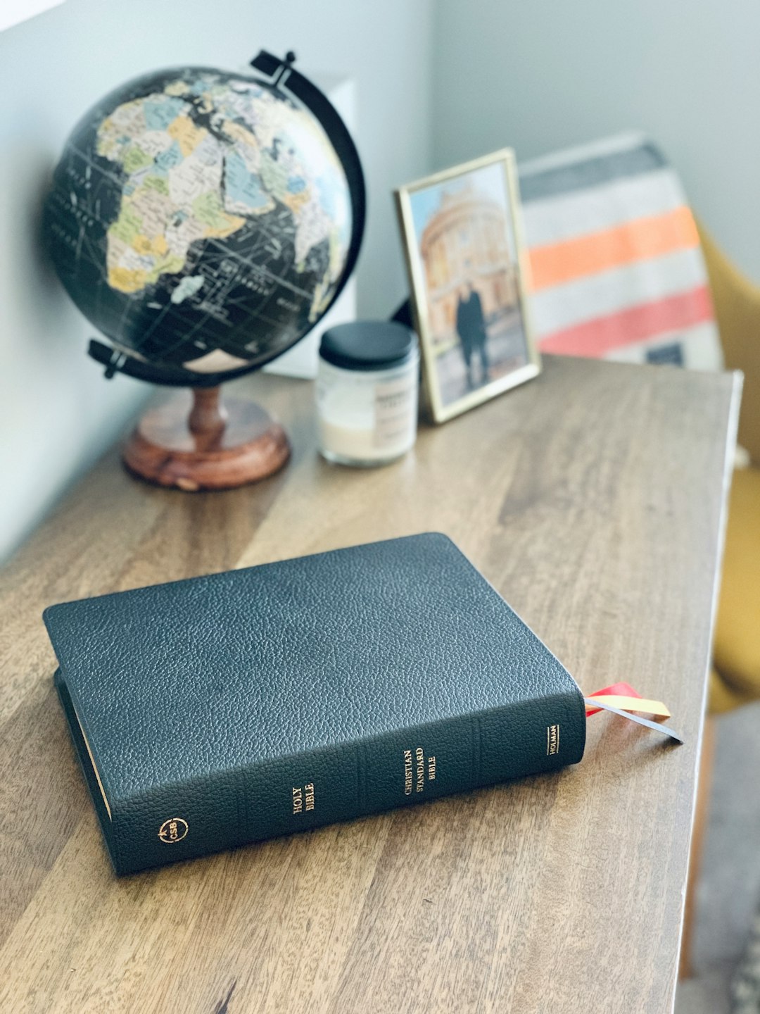 A black leather Bible rests on a table.